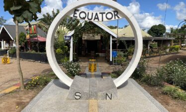 Visitors standing at the Equator line in Uganda